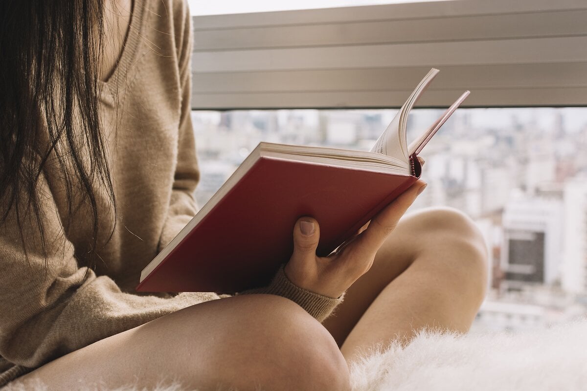 anonymous-female-reading-near-window_1_